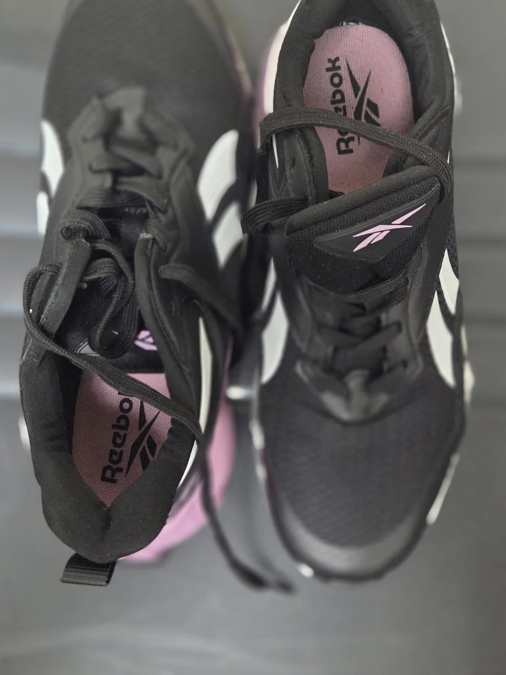 Reebok Black Athletic Sneakers with White Stripes and Pink Logo
